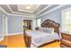 Relaxing bedroom boasts hardwood floors, tray ceiling, and calming neutral colors at 170 Austin Oaks Dr, Ellenwood, GA 30294