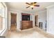 Bedroom with a ceiling fan, dresser, and view into the bathroom at 170 Austin Oaks Dr, Ellenwood, GA 30294