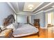 Comfortable bedroom features hardwood floors, tray ceilings, and decorative headboard at 170 Austin Oaks Dr, Ellenwood, GA 30294