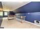 Spacious bonus room with blue walls, carpet, and a staircase leading down at 170 Austin Oaks Dr, Ellenwood, GA 30294