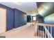 Large bonus room with blue walls, carpet, and stairway with white banister at 170 Austin Oaks Dr, Ellenwood, GA 30294
