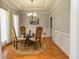 Charming dining room with a glass table, wood floors, and elegant decor at 170 Austin Oaks Dr, Ellenwood, GA 30294