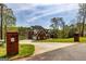 Red brick home with a circular driveway, lake view, and lush landscaping at 170 Austin Oaks Dr, Ellenwood, GA 30294