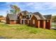 Beautiful red brick home with a large yard, well-maintained lawn, and lake view at 170 Austin Oaks Dr, Ellenwood, GA 30294