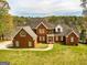 Stately red brick home with expansive lawn and tranquil lake views at 170 Austin Oaks Dr, Ellenwood, GA 30294