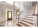 Elegant foyer featuring hardwood stairs, tile floors, and a decorative glass front door at 170 Austin Oaks Dr, Ellenwood, GA 30294