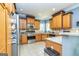 Well-lit kitchen with light wood cabinets, stainless appliances, tiled backsplash, and breakfast bar at 170 Austin Oaks Dr, Ellenwood, GA 30294