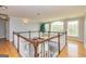 Bright landing area with hardwood floors and large windows offering scenic views at 170 Austin Oaks Dr, Ellenwood, GA 30294