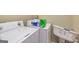 Functional laundry room featuring a washing machine, dryer, and storage space, offering convenience for laundry tasks at 170 Austin Oaks Dr, Ellenwood, GA 30294