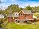 Spacious red brick home featuring a large deck overlooking a lush, green backyard at 170 Austin Oaks Dr, Ellenwood, GA 30294