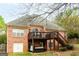 Brick house with a deck and stairs leading to the yard at 101 Westminster Way, Mcdonough, GA 30253