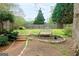 Outdoor sitting area with landscaping and backyard bench at 101 Westminster Way, Mcdonough, GA 30253
