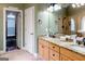 Bathroom featuring double sinks, granite countertops and access to a large walk-in closet with a zebra rug at 101 Westminster Way, Mcdonough, GA 30253