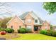 Beautiful brick two-story home with a manicured lawn and mature landscaping creating an inviting curb appeal at 101 Westminster Way, Mcdonough, GA 30253