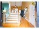Inviting foyer with wood flooring, staircase with wooden banister, and natural light creating a warm and welcoming entrance at 101 Westminster Way, Mcdonough, GA 30253