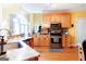 Bright, functional kitchen with wooden cabinets, stainless steel appliances, and a convenient breakfast bar area at 101 Westminster Way, Mcdonough, GA 30253