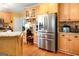 Functional kitchen features stainless steel appliances, wood cabinetry, ample counter space, and hardwood flooring at 101 Westminster Way, Mcdonough, GA 30253
