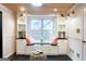 Sunlit sitting area with a window bench, built-in shelving and elegant decor at 101 Westminster Way, Mcdonough, GA 30253