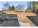 Spacious backyard with a wooden fence, some grass, and patchy snow at 5728 Rock Shoals Way, Atlanta, GA 30349