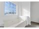 Bathroom featuring a bathtub and a large window providing ample natural light at 5728 Rock Shoals Way, Atlanta, GA 30349
