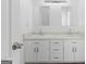 Bathroom with double sinks, and a large mirror with bright lighting at 5728 Rock Shoals Way, Atlanta, GA 30349