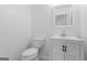 Well lit bathroom with a white toilet, cabinet, and mirror at 5728 Rock Shoals Way, Atlanta, GA 30349