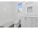 Bathroom featuring a bathtub, toilet, vanity with sink, and a large window at 5728 Rock Shoals Way, Atlanta, GA 30349
