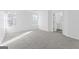 Bedroom with a large carpeted floor with a spacious closet and two windows at 5728 Rock Shoals Way, Atlanta, GA 30349