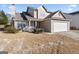 Two-story home with a two-car garage and a front porch at 5728 Rock Shoals Way, Atlanta, GA 30349