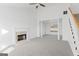 Bright living room featuring a fireplace, large window, and neutral carpet at 5728 Rock Shoals Way, Atlanta, GA 30349