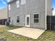 Back exterior displaying a grey exterior siding, small patio and an enclosed backyard providing a private outdoor space at 789 Galveston Way, Mcdonough, GA 30253