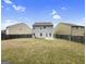 Large backyard with green lawn, fenced perimeter, and two-story home, ideal for outdoor living and entertainment at 789 Galveston Way, Mcdonough, GA 30253