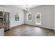 Bright dining area features modern chandelier, two windows and a door to the back at 789 Galveston Way, Mcdonough, GA 30253