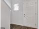Bright foyer features hardwood floors, a white door, and a window that provides ample natural light at 789 Galveston Way, Mcdonough, GA 30253