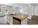 Open kitchen with granite countertops, stainless dishwasher, and view into the living room at 789 Galveston Way, Mcdonough, GA 30253