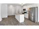 Bright kitchen features white cabinets, stainless appliances, granite countertops and a center island at 789 Galveston Way, Mcdonough, GA 30253