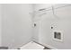 Functional laundry room with washer hookups and shelving for storage solutions at 789 Galveston Way, Mcdonough, GA 30253