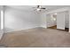 Bright living room features a ceiling fan and neutral carpet, ready for personalization at 789 Galveston Way, Mcdonough, GA 30253
