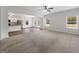 Spacious living area with carpet flooring that flows seamlessly into the adjacent kitchen at 789 Galveston Way, Mcdonough, GA 30253