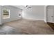 Empty living room featuring plush carpet and windows providing natural light at 789 Galveston Way, Mcdonough, GA 30253