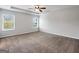 Bright, carpeted main bedroom with two windows, features a ceiling fan and recessed lighting at 789 Galveston Way, Mcdonough, GA 30253