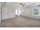 Well-lit main bedroom with ceiling fan and two windows; has neutral-colored carpet at 789 Galveston Way, Mcdonough, GA 30253