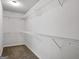 Spacious walk-in closet featuring wire shelving for optimal storage in neutral color palette at 789 Galveston Way, Mcdonough, GA 30253