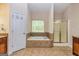 A relaxing bathroom features a tiled surround tub, and separate shower at 1015 Middlebrook Dr, Mcdonough, GA 30252