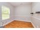 Small bedroom with hardwood floors, wainscoting and a bright window view at 1015 Middlebrook Dr, Mcdonough, GA 30252