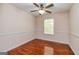 A light and airy bedroom with wood floors and a ceiling fan at 1015 Middlebrook Dr, Mcdonough, GA 30252