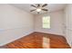 A light and airy bedroom with wood floors and a ceiling fan at 1015 Middlebrook Dr, Mcdonough, GA 30252