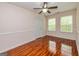 A light and airy bedroom with wood floors and a ceiling fan at 1015 Middlebrook Dr, Mcdonough, GA 30252