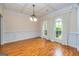 Elegant dining room with hardwood floors, wainscoting, coffered ceilings, and arched windows at 1015 Middlebrook Dr, Mcdonough, GA 30252