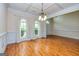 Open dining area with hardwood floors, trim, and arched windows creating a bright atmosphere at 1015 Middlebrook Dr, Mcdonough, GA 30252